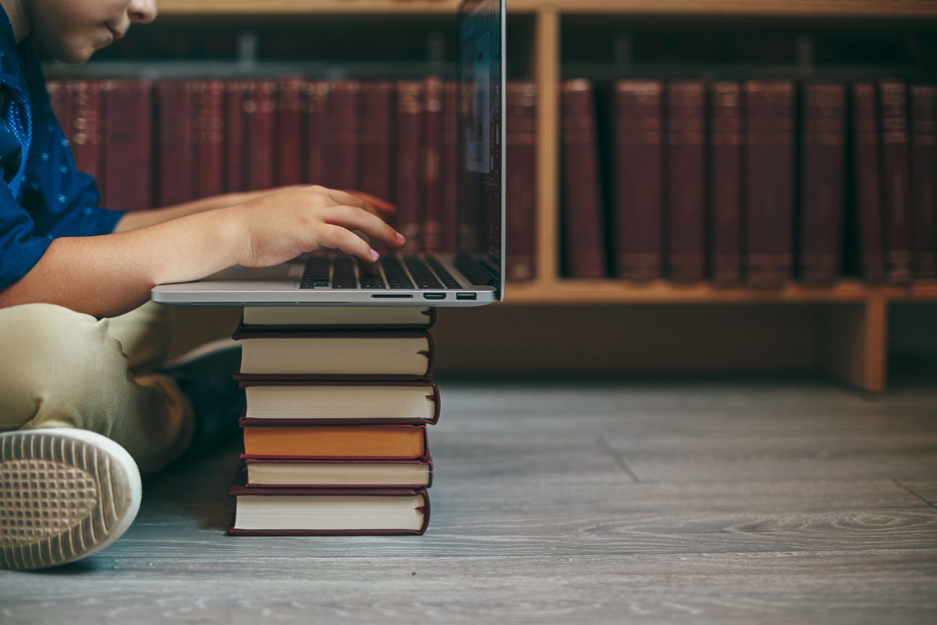 laptop on a stack of books 2026 03 09 09 17 19 utc