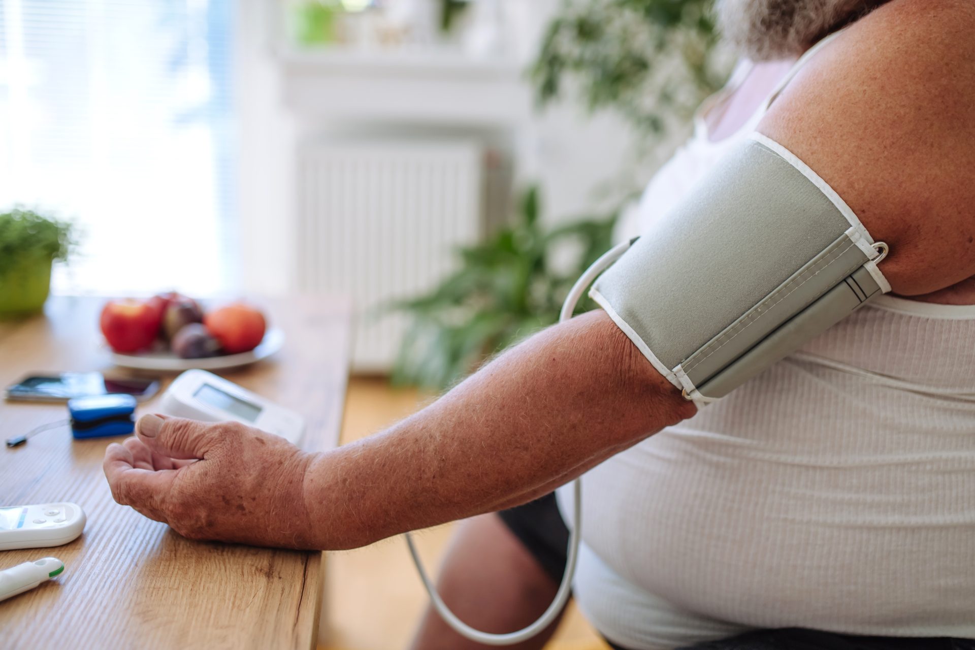 adult checking blood pressure at home on table 2026 03 10 02 07 21 utc