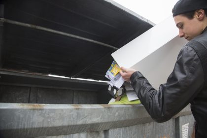 young adult discarding waste in outdoor setting 2026 01 09 09 21 01 utc