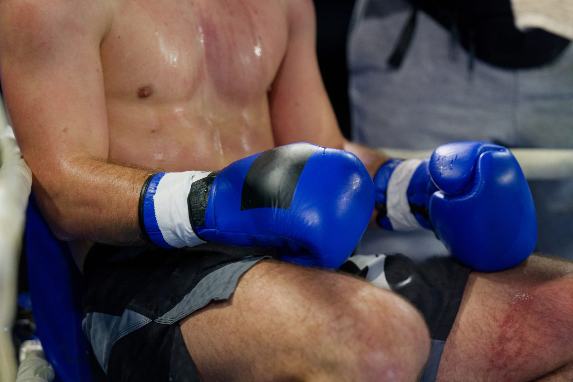sweaty boxer sitting with boxing gloves on 2026 01 07 05 33 30 utc